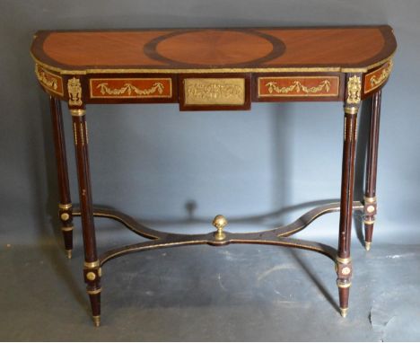 A French Style Kingwood and Gilt Metal Mounted Console Table, the shaped circular inlaid top above a relief decorated frieze 