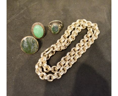 A Silver Dress Ring set with large oval cabochon jade, together with two other silver dress rings and a linked chain 