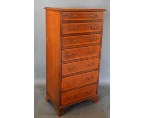 An Edwardian Mahogany Chest, the moulded top above seven drawers with brass handles raised upon bracket feet, 60cm wide, 40cm