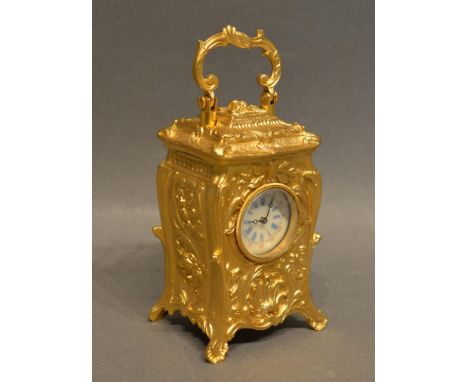 A Miniature Brass Cased Carriage Clock of Rococo Form, the dial roman numerals and shaped handle 7cm tall 