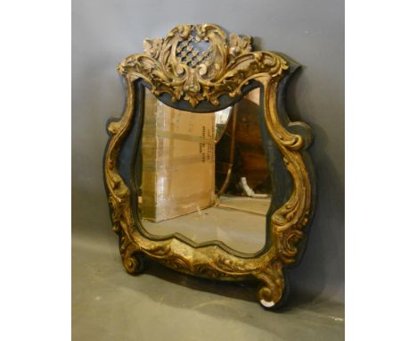 A 19th Century French Carved Wood and Gesso Wall Mirror of scroll shaped from 107cm high by 94cm wide 