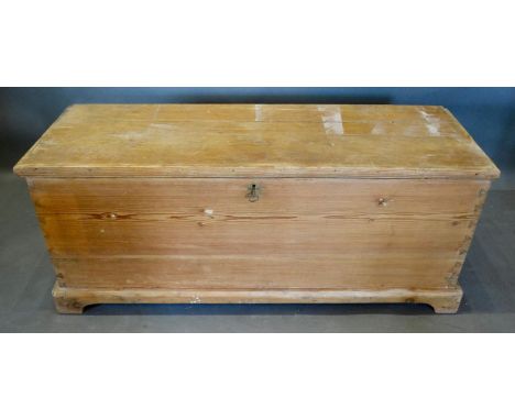 A Late 19th/Early 20th Century Pine Trunk with a hinged top raised upon bracket feet, 120cm wide, 42cm deep, 51cm high 
