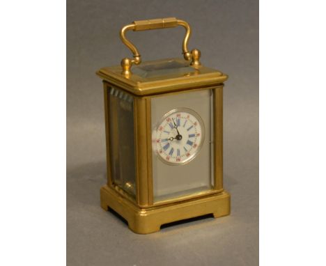 A Brass Cased Miniature Carriage Clock the silvered and enamel dial with roman numerals and lever escapement and carrying han