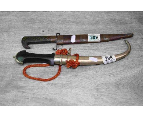 Two vintage Middle Eastern Daggers with scabbards to include Jambiya style