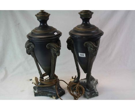 Pair of Classical style metal Lamps with Rams head masque tripod supports