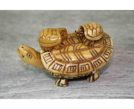 Bone netsuke figure of a turtle with two babies to back