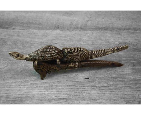 Ornate Bone Handled Betel Nut Cutter, the handle carved as animals and set with Ruby Coloured Stones