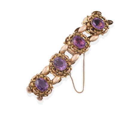 An Early 20th Century Amethyst Bracelet, comprised of eight panels each with an oval cut amethyst in crimped setting, within 