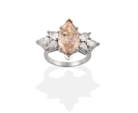 A Fancy Diamond Ring, a light brown marquise cut diamond within two spray clusters of three pear cut diamonds, total estimate