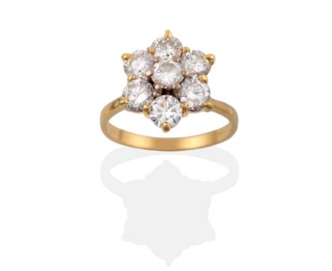 A Diamond Cluster Ring, seven round brilliant cut diamonds in yellow claw settings, to a tapered plain polished shank, total 