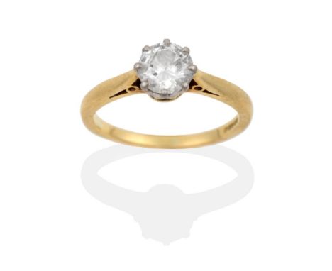 An 18 Carat Gold Diamond Solitaire Ring, the round brilliant cut diamond in a white claw setting, to a yellow tapered plain p