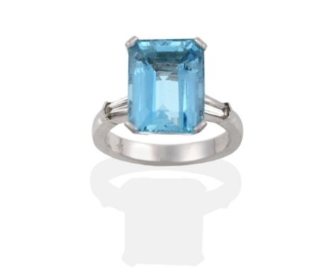 A Platinum Aquamarine and Diamond Ring, the octagonal-cut aquamarine in a corner claw setting, to tapered baguette cut diamon