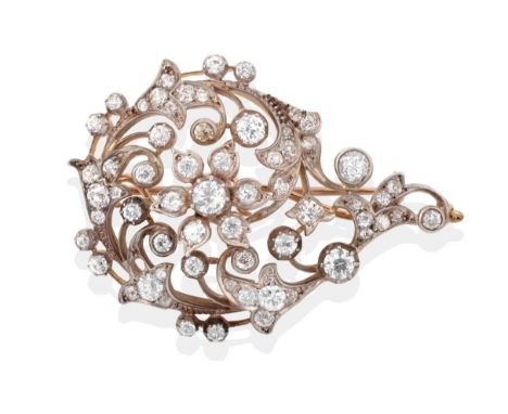 A Late 19th Century Diamond Brooch, old cut diamonds create a floral centre within a swirling foliate motif, in claw and coll