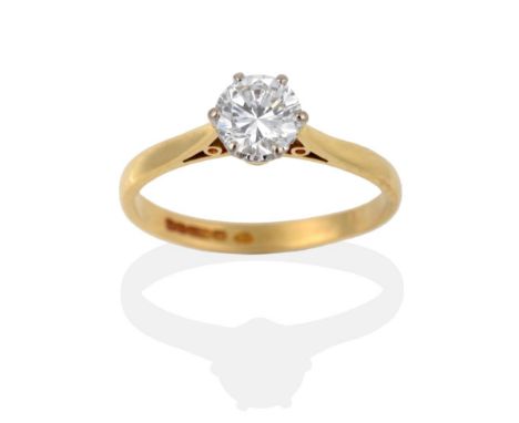 An 18 Carat Gold Diamond Solitaire Ring, the round brilliant cut diamond in a white six claw setting to a yellow tapered shou