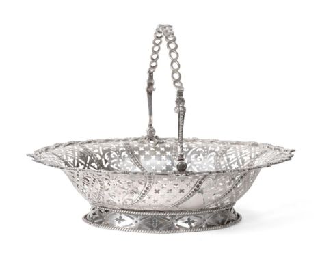 A George III Silver Swing-Handled Cake Basket, William Plummer, London 1765, oval with foliate rim, the sides pierced with al