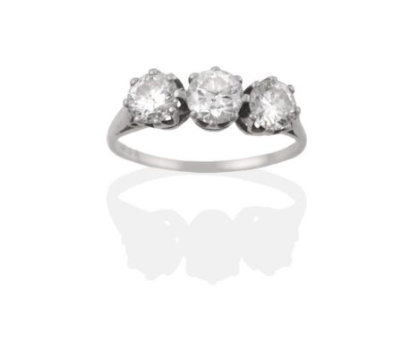 A Diamond Three Stone Ring, three round brilliant cut diamonds in white claw settings, to a tapered shoulder plain polished s