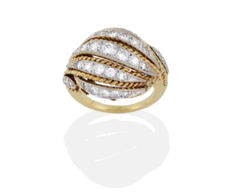 A Fancy Diamond Ring, comprised of rows of graduated round brilliant cut diamonds diagonally set with yellow rope twist decor