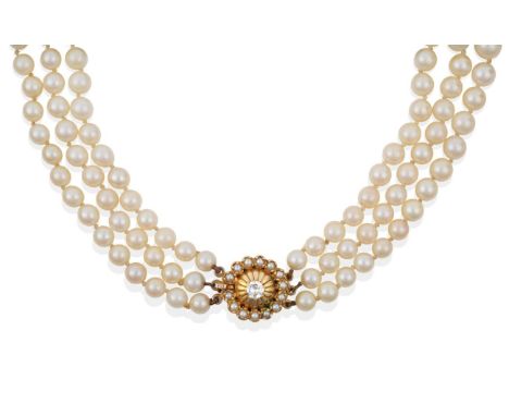 A Three Strand Cultured Pearl Necklace, with a Diamond and Seed Pearl Clasp, the 57:61:63 uniform cultured pearls measuring b