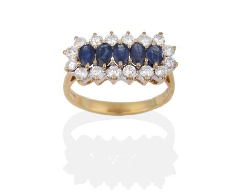 An 18 Carat Gold Sapphire and Diamond Cluster Ring, five oval cut sapphires in yellow claw settings, within a border of round