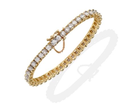A Diamond Line Bracelet, round brilliant cut diamonds in articulated channel settings, total estimated diamond weight 4.75 ca