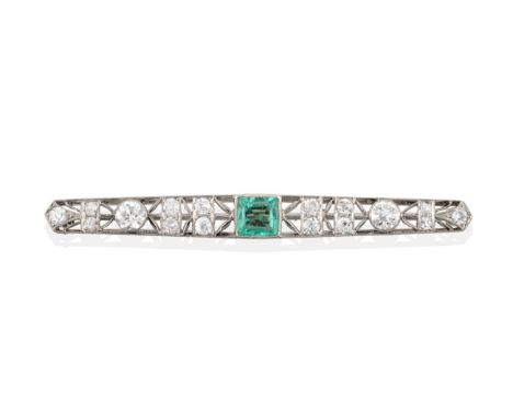 An Early 20th Century Emerald and Diamond Bar Brooch, the square step cut emerald in a millegrain setting to a bar of open de