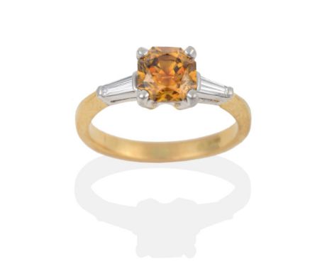 An 18 Carat Gold Diamond Solitaire Ring, the octagonal mixed cut light yellowish brown diamond in white claws to tapered bagu