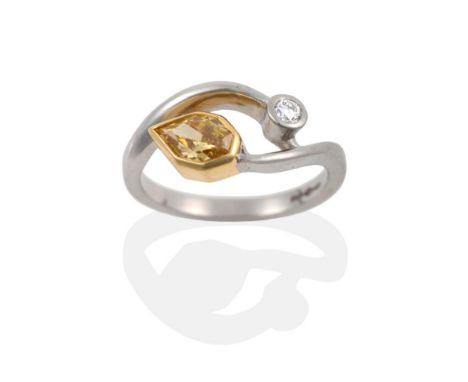 A Platinum Yellow and White Diamond Ring, in a crossover style, a yellow Empress cut diamond in a yellow rubbed over setting 