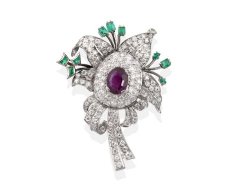 An Amethyst, Diamond and Emerald Brooch, an oval mixed cut amethyst centres a floral design, pavé set throughout with round b