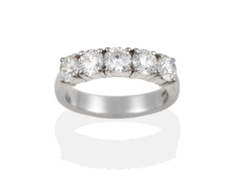 A Platinum Diamond Five Stone Ring, the round brilliant cut diamonds in claw settings, on a plain polished shank, total estim