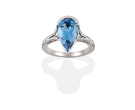 An Aquamarine and Diamond Ring, a pear cut aquamarine in a white semi-rubbed over setting to forked shoulders inset with roun