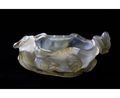 A small 19th century Chinese jade brush washer bowl carved as a lotus leaf with toad and shells to the rim and slight 'russet