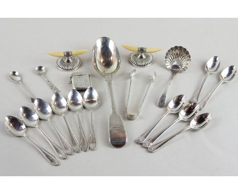A collection of small items of silver to include two sets of six teaspoons, a pair of ivory and silver knife rests, a Vesta c