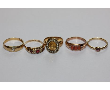 A diamond single stone ring; a citrine and pearl ring; a coral ring; a ruby and diamond ring and another