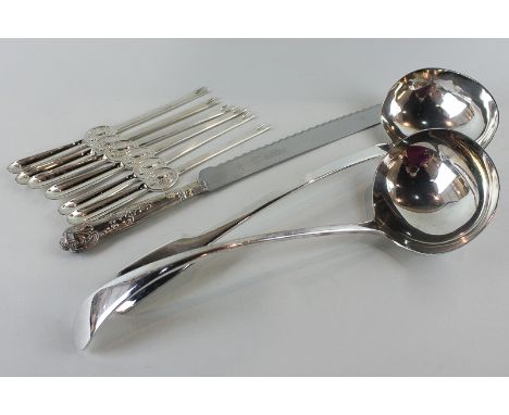 A plated Old English pattern soup ladle, another fiddle pattern soup ladle, a bread knife and six lobster picks