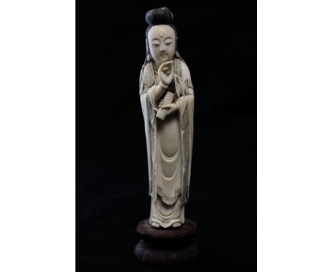 A late 19th, early 20th century Chinese carved ivory figure of 'Lancaihe Guanxce' standing holding leaves and a scroll, on wo