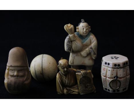 A 19th century carved ivory netsuke, head of a bearded man, together with an ivory netsuke of a tradesman, an ivory ball pend