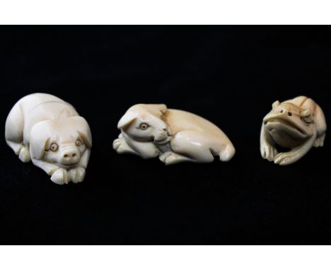 Three small Japanese carved ivory netsuke, a crouching dog, a resting horse and a toad, all signed