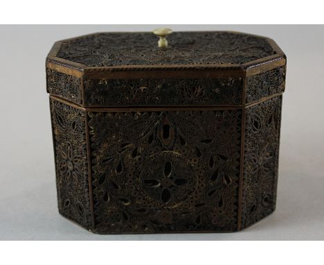An 18th century 'straw work' tea caddy, the octagonal sides and hinged top worked with panels of straw in a leaf and flower p
