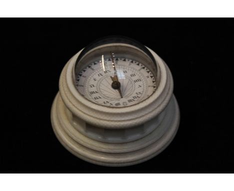 A Victorian ivory cased compass with  glass dome top and decorated base