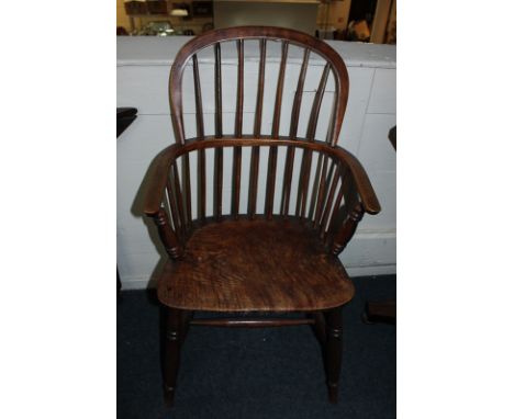 A 19th century stick back Windsor elbow chair with elm seat on turned legs