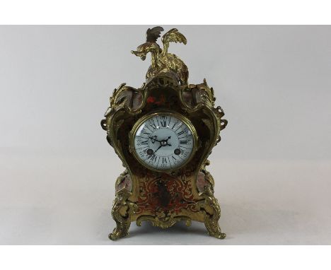 A late 19th, early 20th century French mantel clock in red tortoiseshell and cut brass, cast with dragon cresting and white e