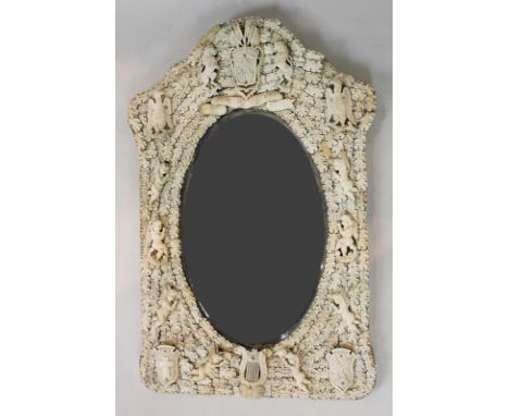 A Dieppe bone decorated hanging mirror with figures, shields, harps and cupids, 82cm by 48cm (NC)