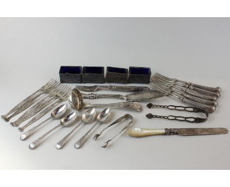 A collection of silver items to include butter knife, sifter ladle, five forks and tongs (sterling), sugar tongs, four salts 