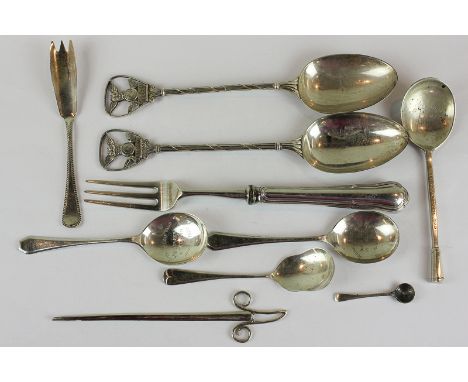 A pair of silver serving spoons, London 1934, with owl and clock decorated handles, together with four other spoons, salt spo