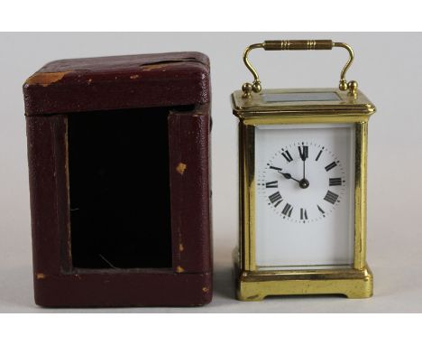 A 20th century brass and bevelled glass case carriage clock with white enamelled dial and Roman numerals, with eight-day Fren