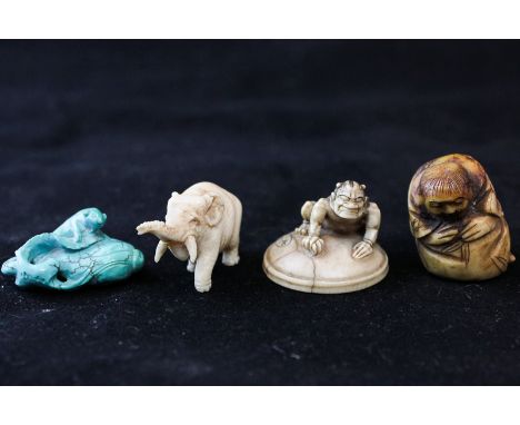 Four small oriental items to include a crouching ivory devil on top of a smiling child's mask under circular base, signed (re