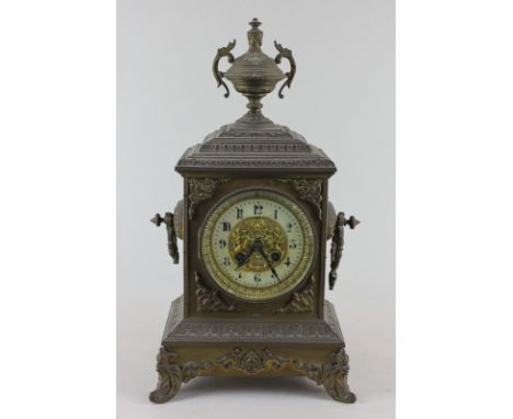 A Victorian mantle clock in embossed brass case, with urn surmount, white enamel chapter ring and gilt bezel, 41cm high (NC)