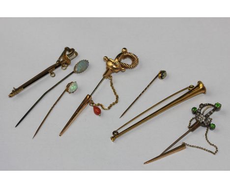 A late Victorian diamond and green garnet stick pin in the form of a sword and scabbard (some diamonds missing; another hung 