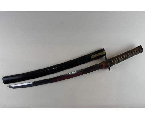 A 19th century Japanese short sword in black lacquered scabbard with metal tsuba with shagreen and bound handle and metal fuc