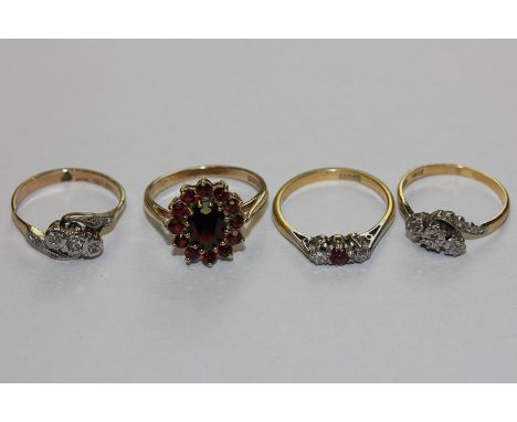 A ruby and diamond three stone ring in 18ct white and yellow gold; two illusion set three stone rings; a garnet cluster ring